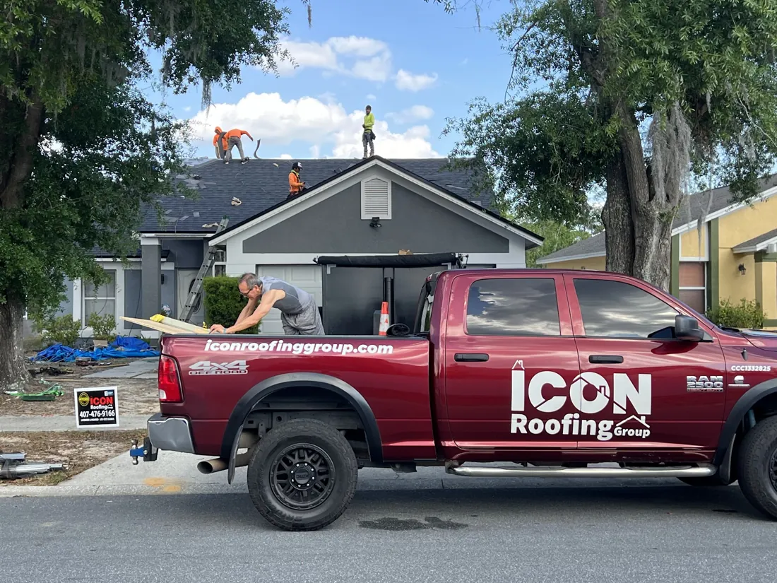 Icon Roofing Group truck and crew on a roof replacement job