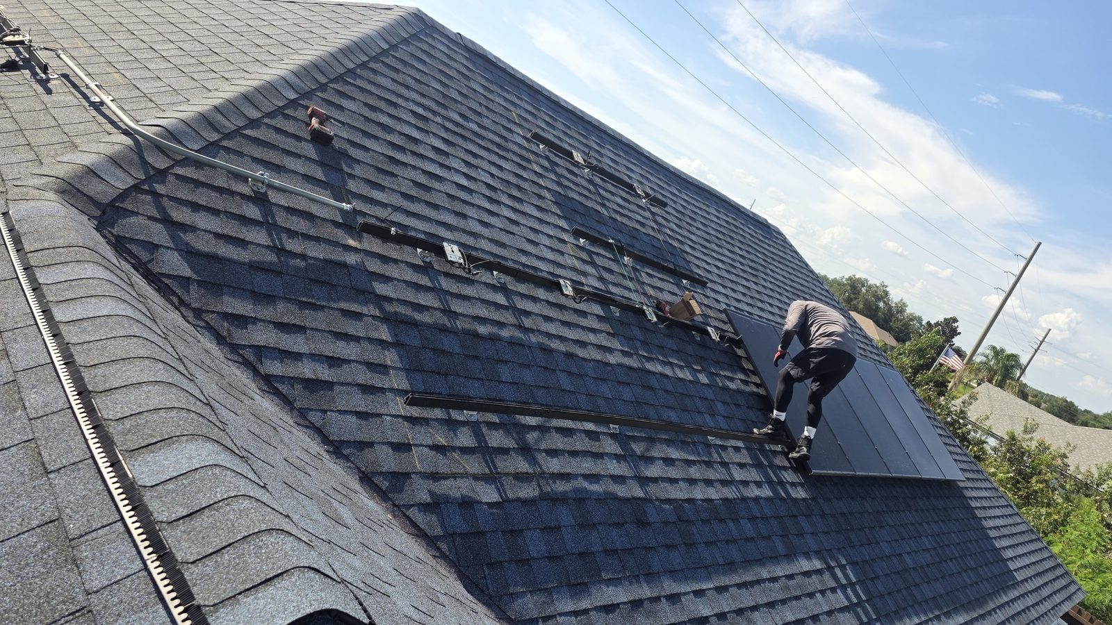 Icon Roofing Group technician installing solar panel mounting rails on a roof