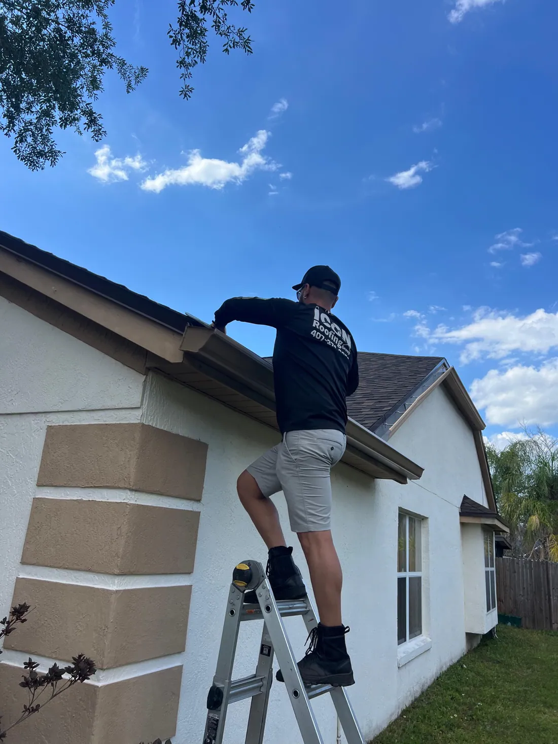 Icon Roofing Group crew member working on a roof gutter, Orlando