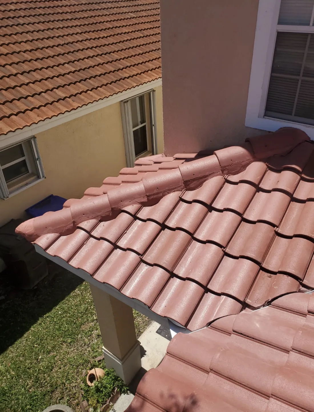 Red barrel tile roof installed along a home wall, Central Florida